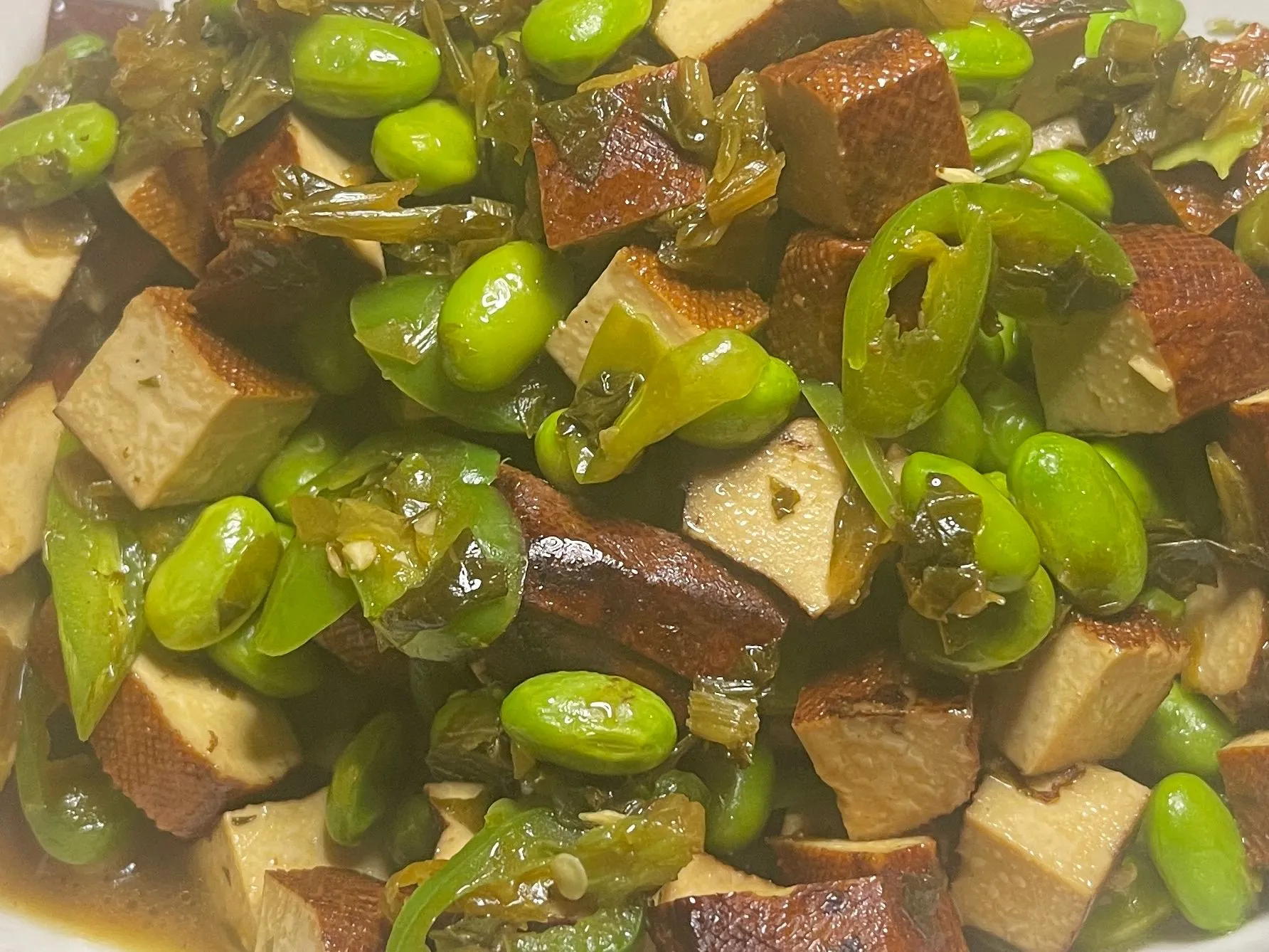 Braised edamame and smoked tofu cubes with pickled greens and green chili at 面滋味 Tasty Noodle House, a Chinese Restaurant in Plano